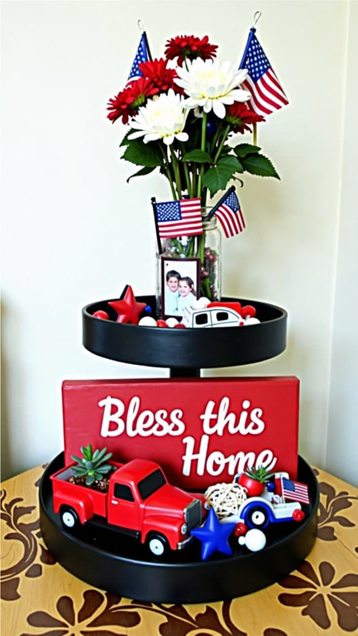 Patriotic 4th of July tiered tray decor featuring a 'Bless This Home' sign, red toy truck, American flags, red and white flowers, and festive star accents.