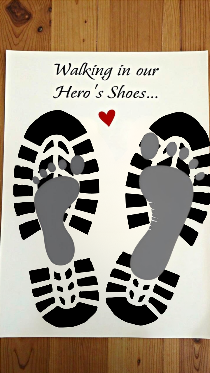 DIY Father's Day footprint art featuring a large pair of black footprints with smaller gray footprints inside, captioned 'Walking in Our Hero’s Shoes' with a red heart.
