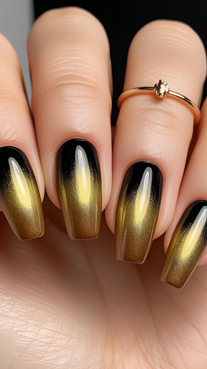 Close-up of golden cat eye nails with a magnetic shimmer fading into deep black.