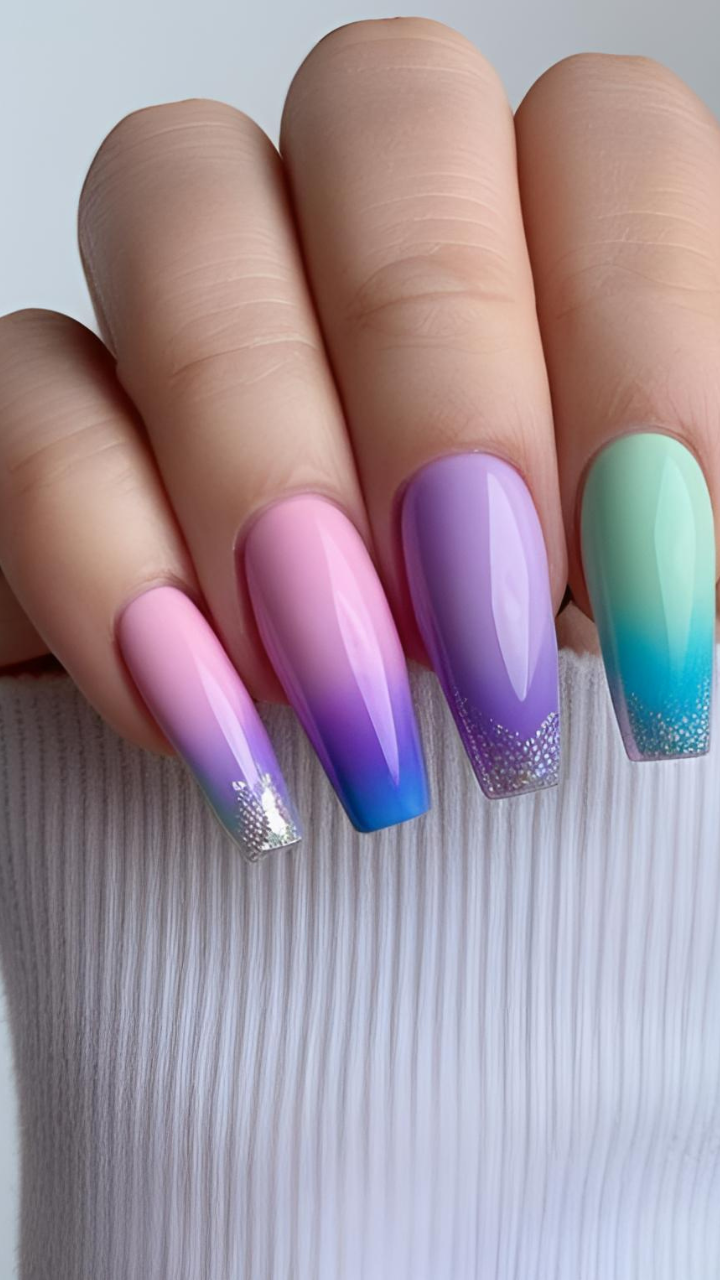 Pastel ombre coffin nails with pink, purple, and mint green gradient colors and glitter tips