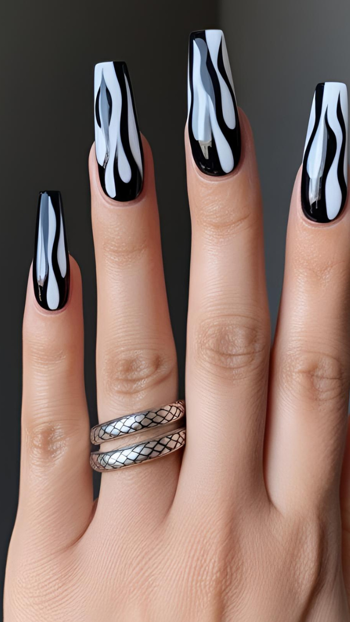 Black coffin nails with white flame nail art design on a glossy finish