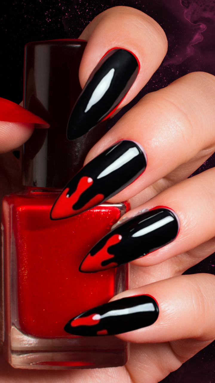 Gothic black and red drip nails with stiletto tips.