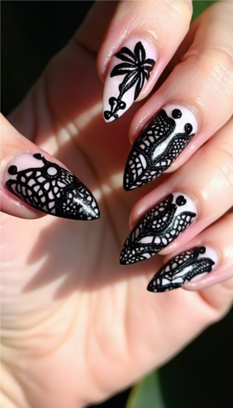 Black lace goth nail art on almond-shaped nails with a pale pink base and intricate detailing.